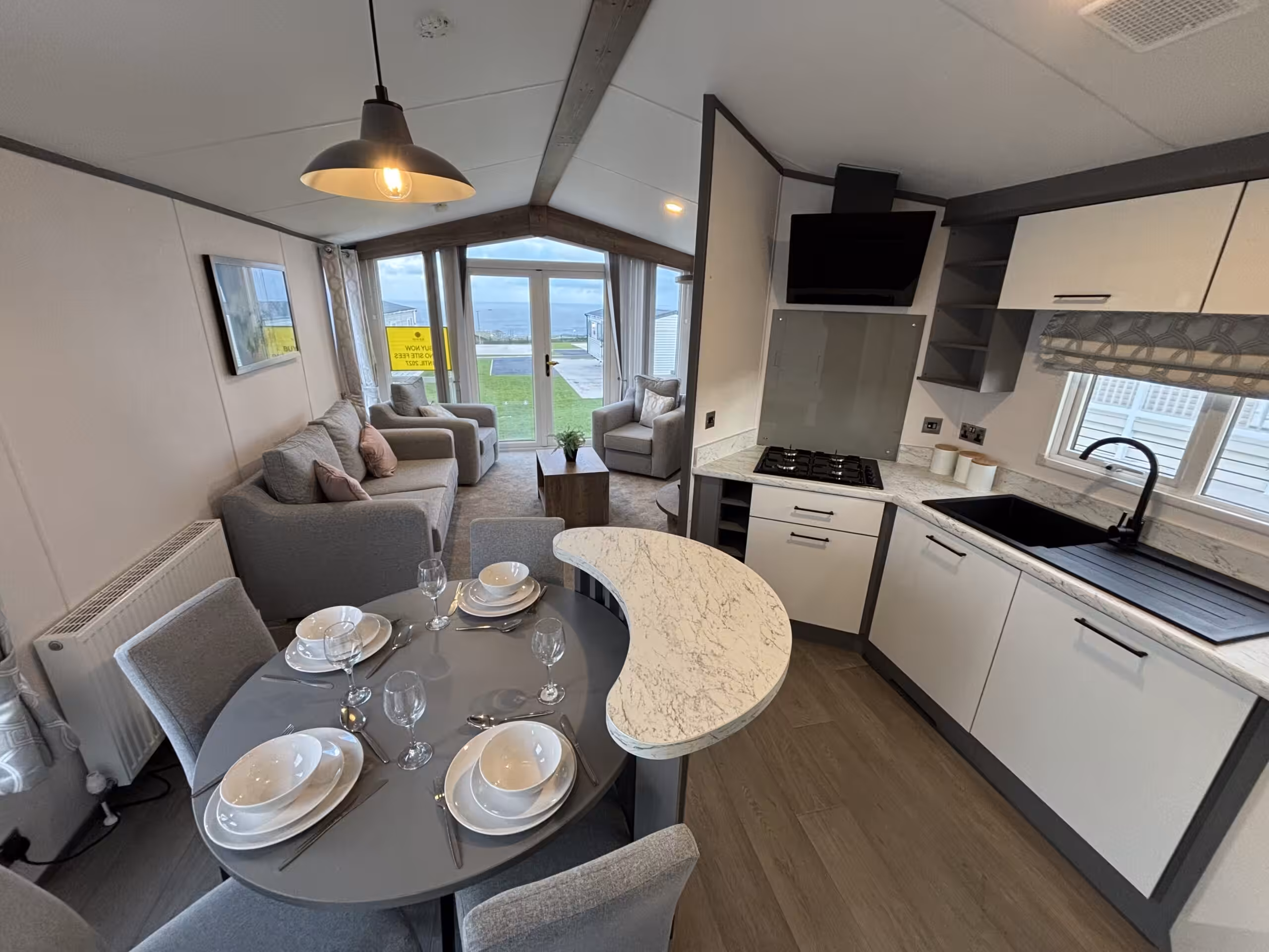 Kitchen and dining area in the 2023 Atlas Status on sale at Elm Bank Coastal Park in Berwick-upon-Tweed, Northumberland.