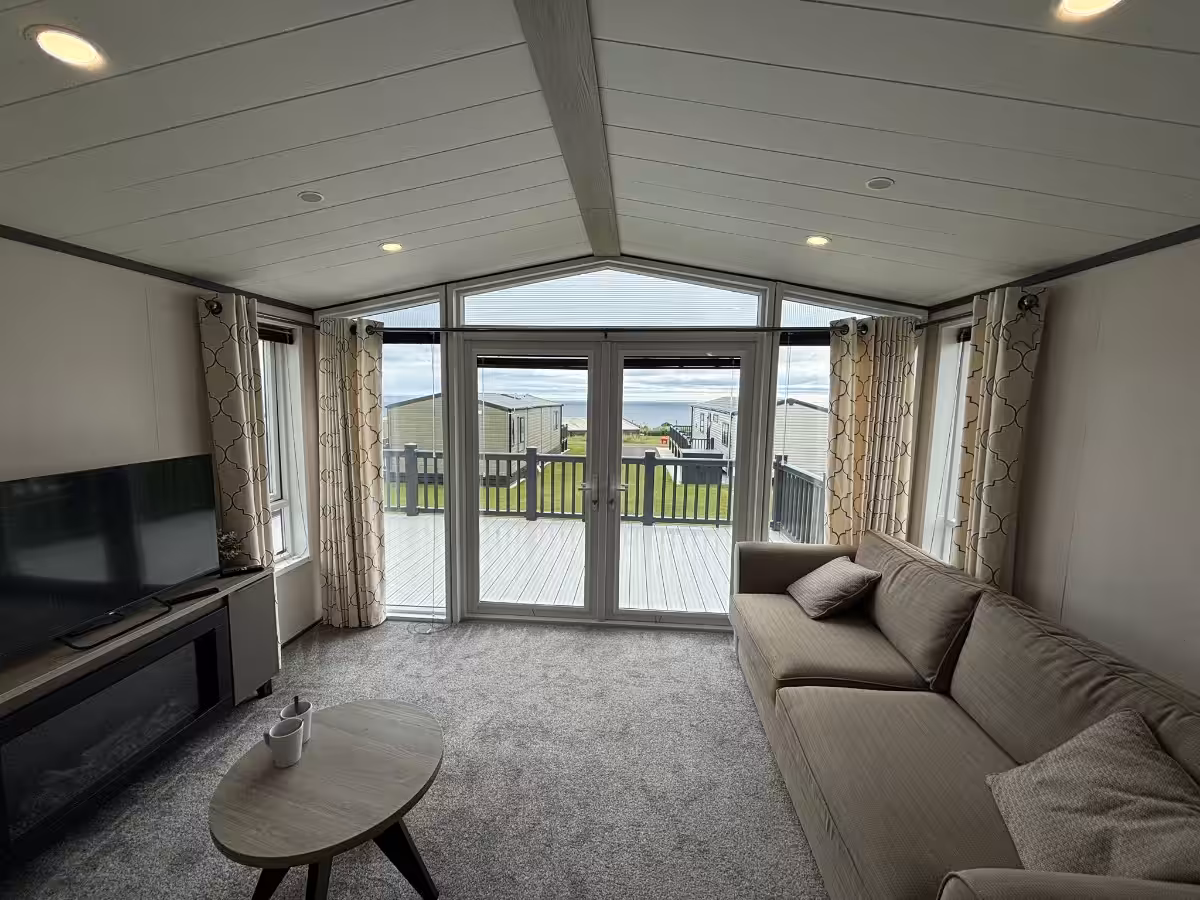 Living room and patio doors in the 2021 Victory Lakewood Lodge for sale at Elm Bank Coastal Park in Spittal, Berwick-upon-Tweed, Northumberland.