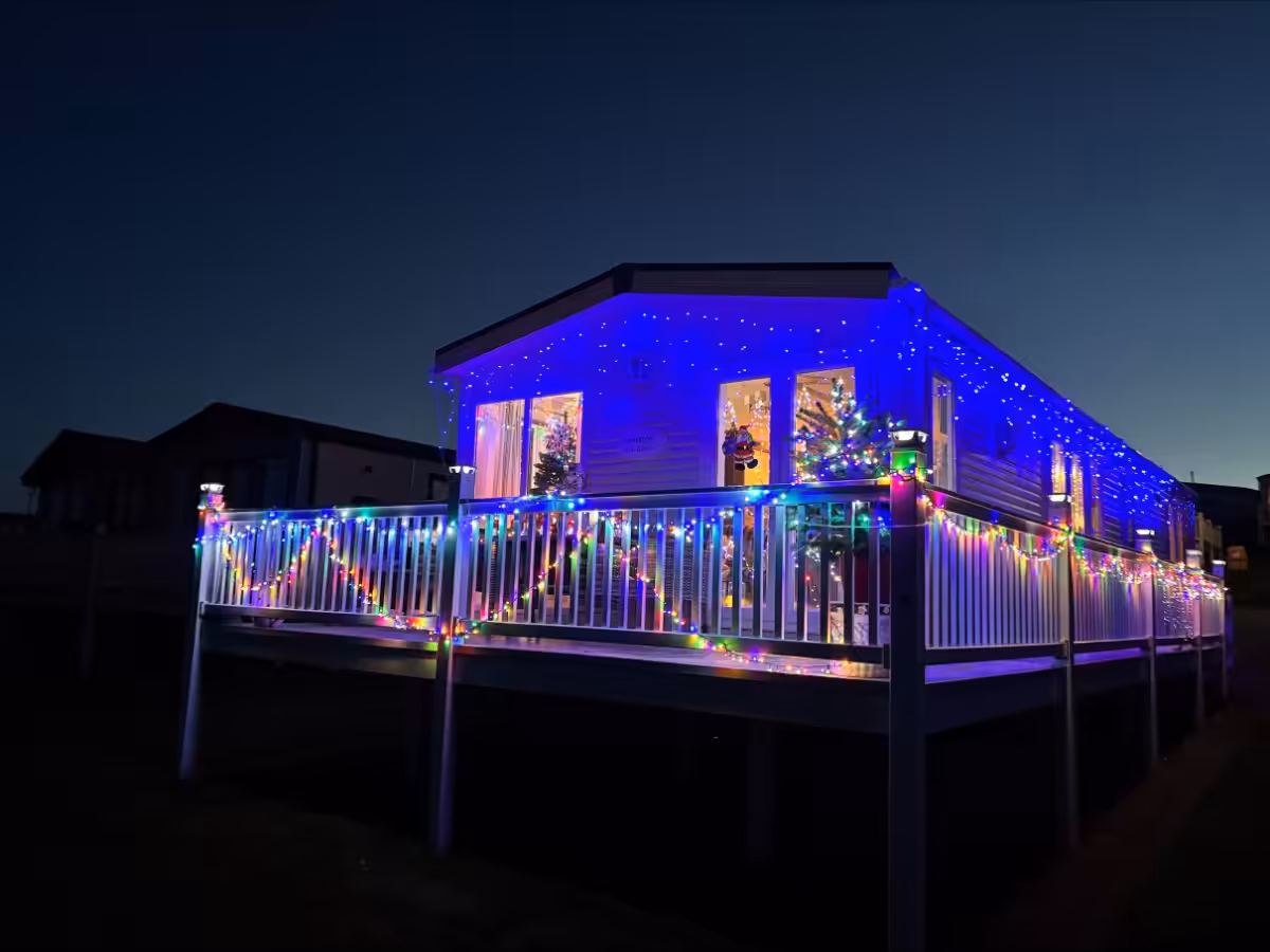 An owners caravan at Elm Bank Coastal Park in Berwick, Northumberland, decorated with bright colorful Christmas lights and decorations