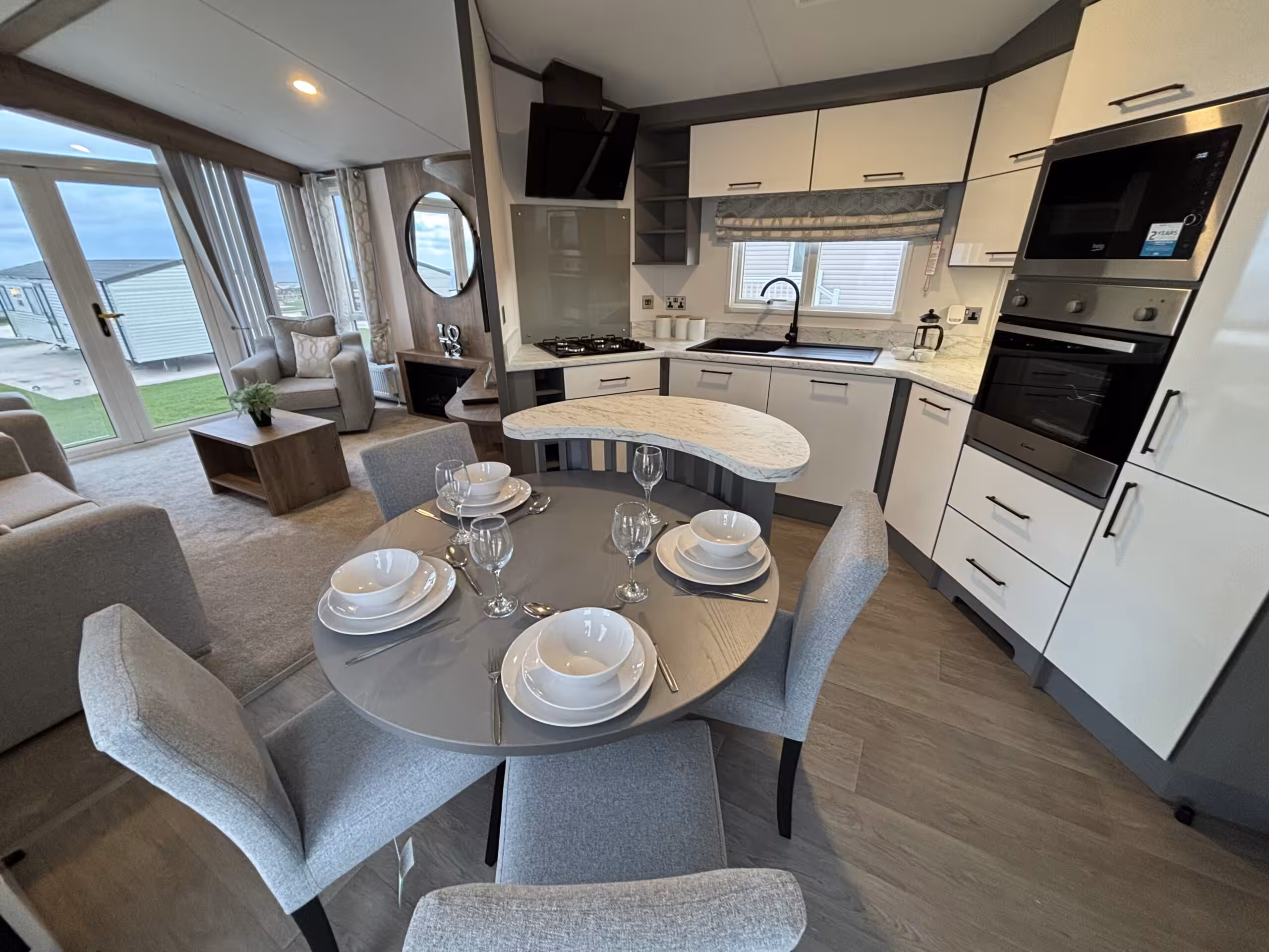 Kitchen and dining areas in the 2023 Atlas Status on sale at Elm Bank Coastal Park in Berwick-upon-Tweed, Northumberland.