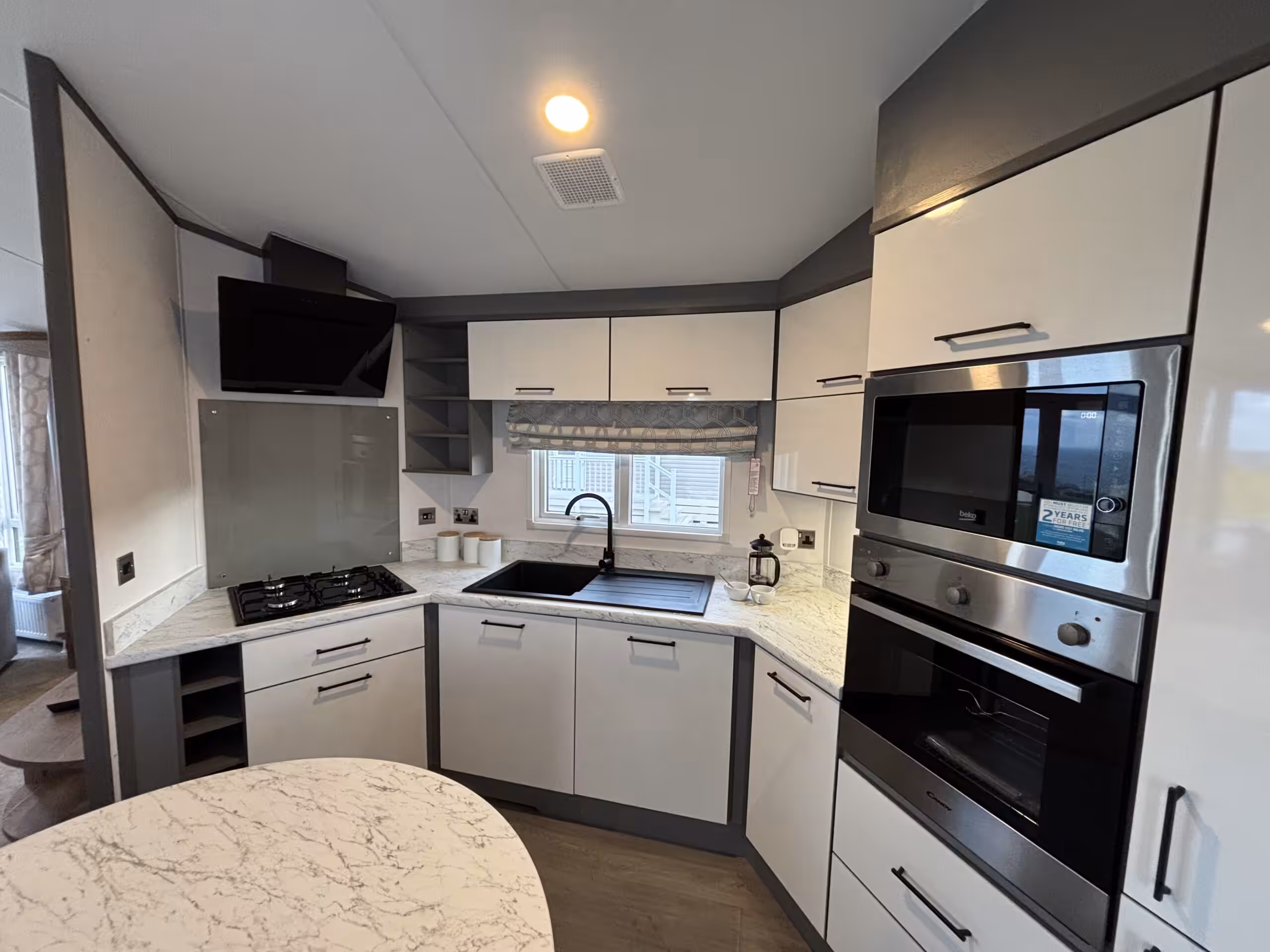 Kitchen area in the 2023 Atlas Status on sale at Elm Bank Coastal Park in Berwick-upon-Tweed, Northumberland.