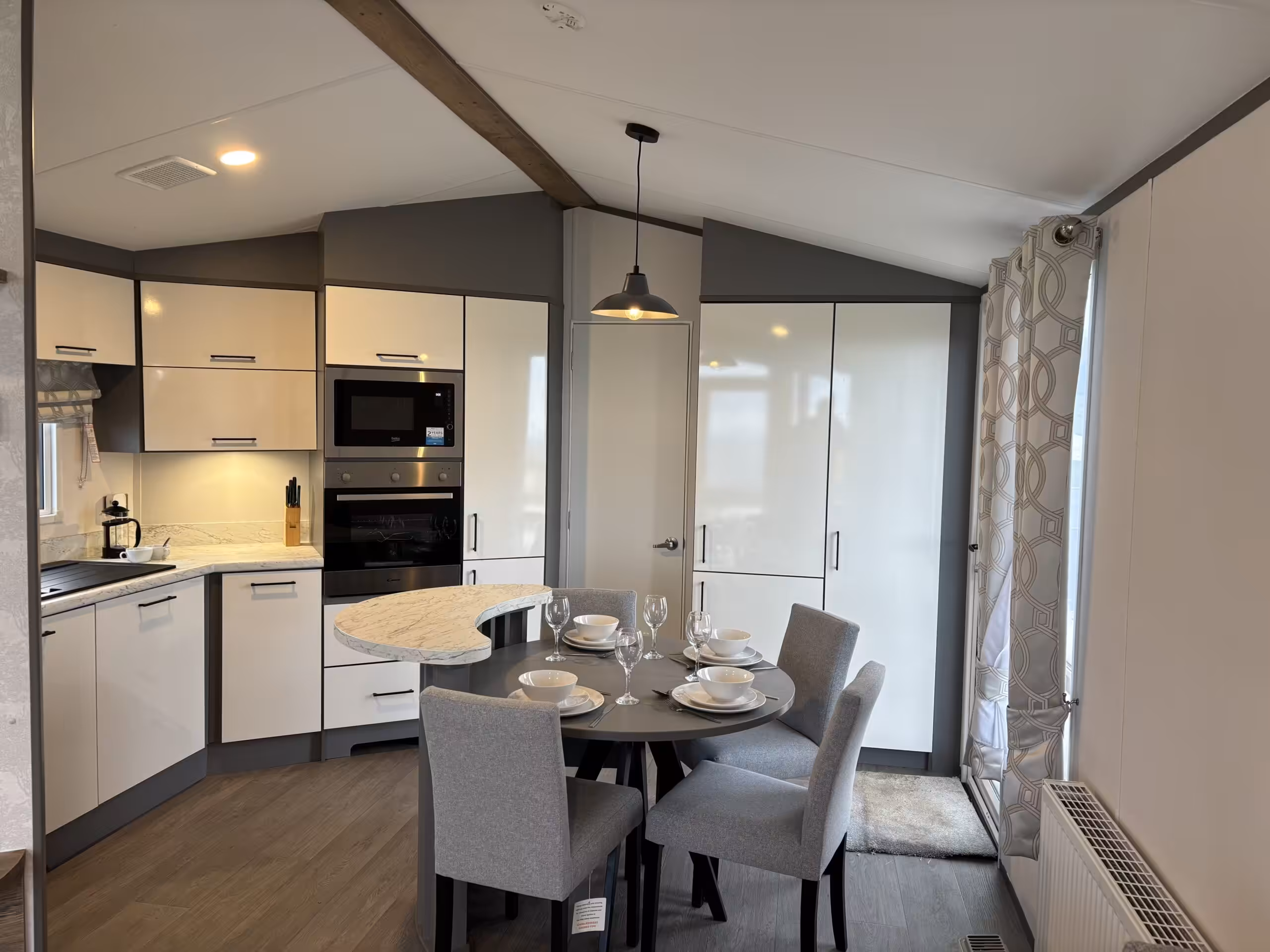 Dining area in the 2023 Atlas Status on sale at Elm Bank Coastal Park in Berwick-upon-Tweed, Northumberland.