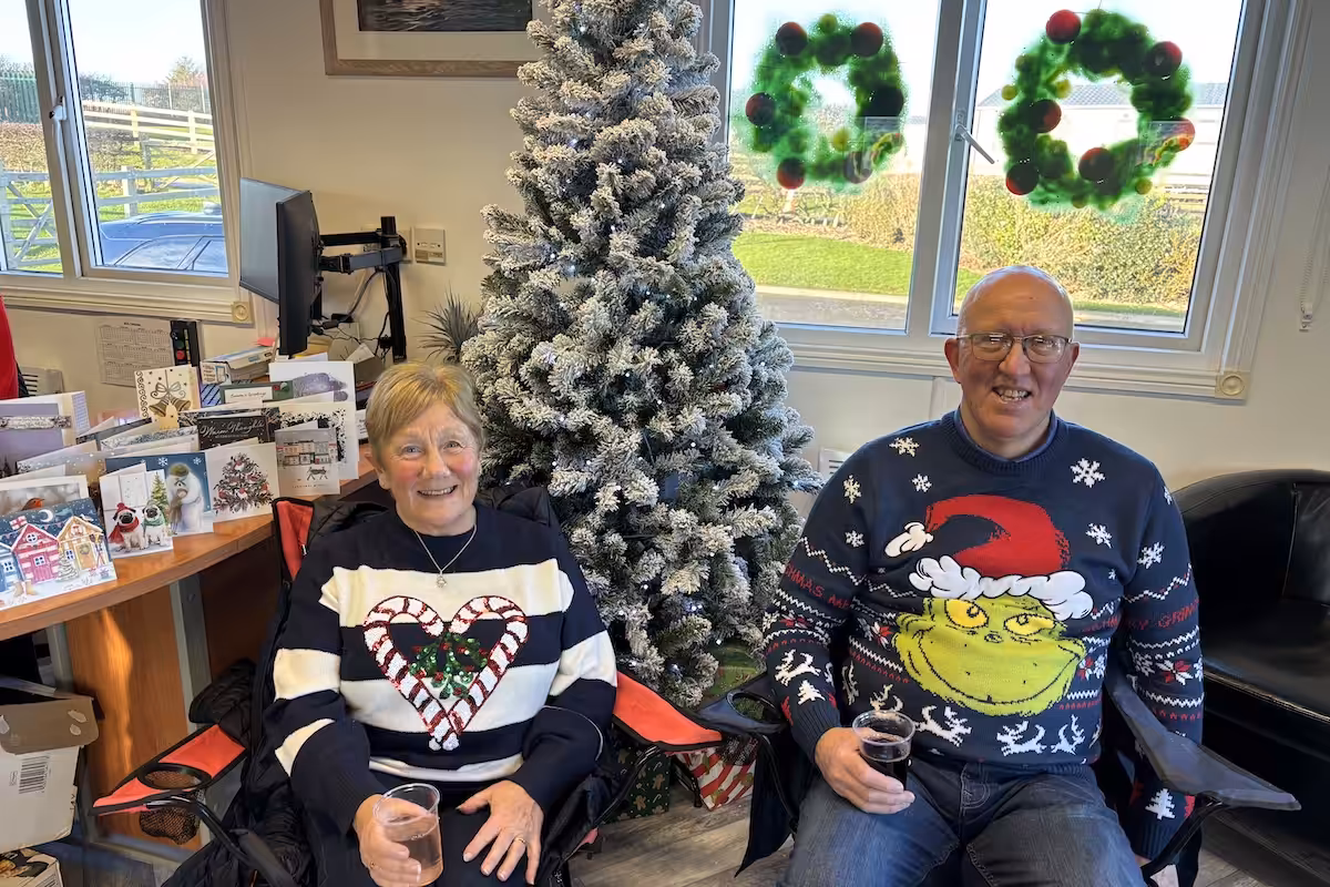 A couple displaying there fabulous colorful Christmas jumpers for the owners of Elm Bank Coastal Park in Berwick, Northumberland annual Christmas Jumper Day