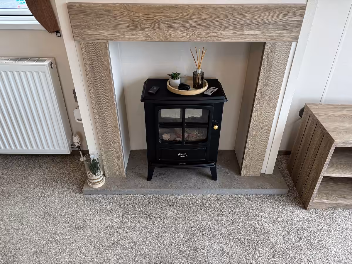 Feature fire place in the living area of the 2021 ABI Adderstone Elite for sale at Elm Bank Coastal Park in Berwick, Northumberland.