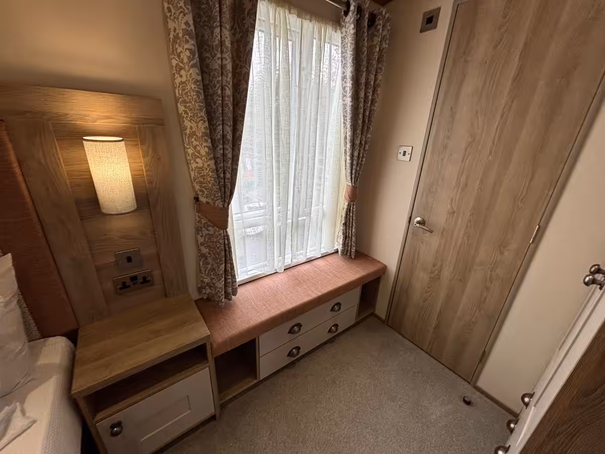 Seating and storage in master bedroom in the 2021 ABI Adderstone Elite for sale at Elm Bank Coastal Park in Berwick, Northumberland.