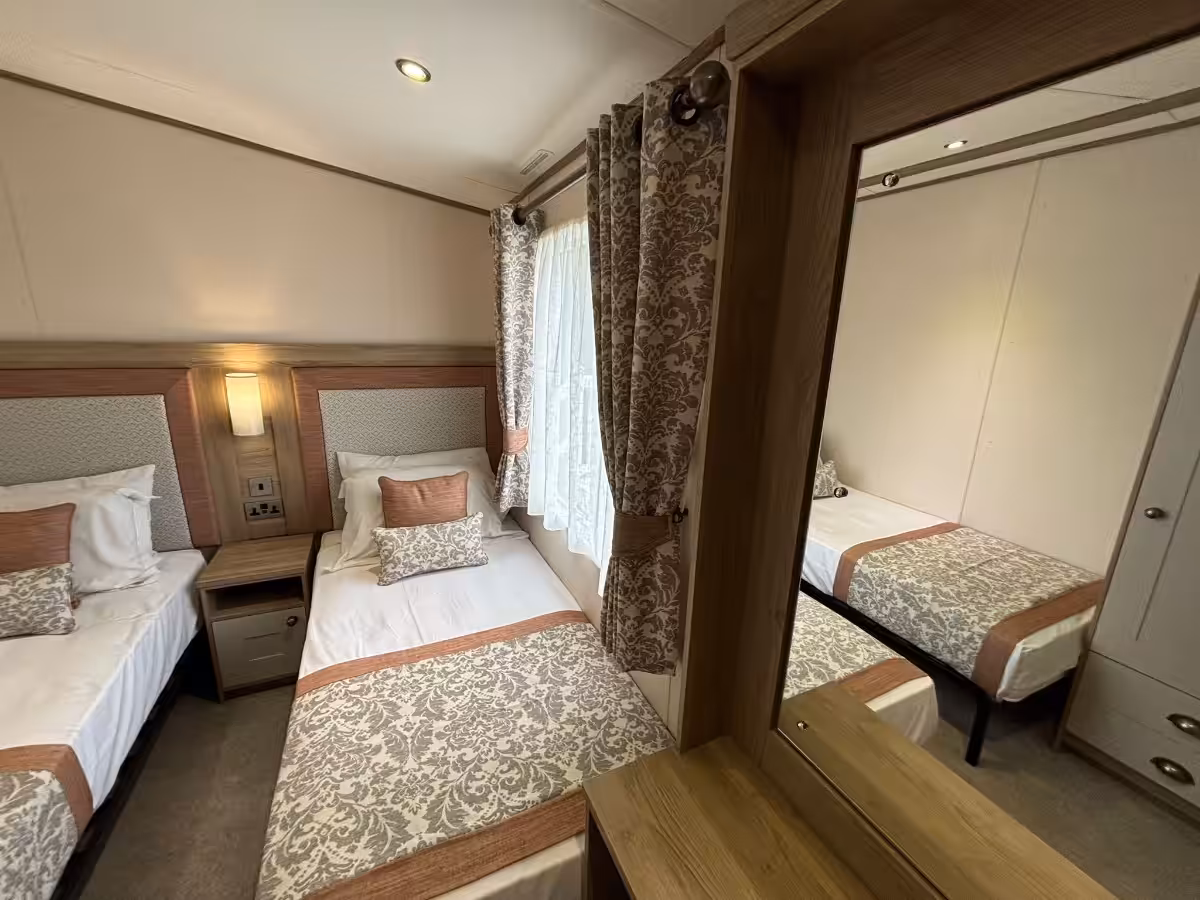 Twin bedroom and mirror in the 2021 ABI Adderstone Elite for sale at Elm Bank Coastal Park in Berwick, Northumberland.