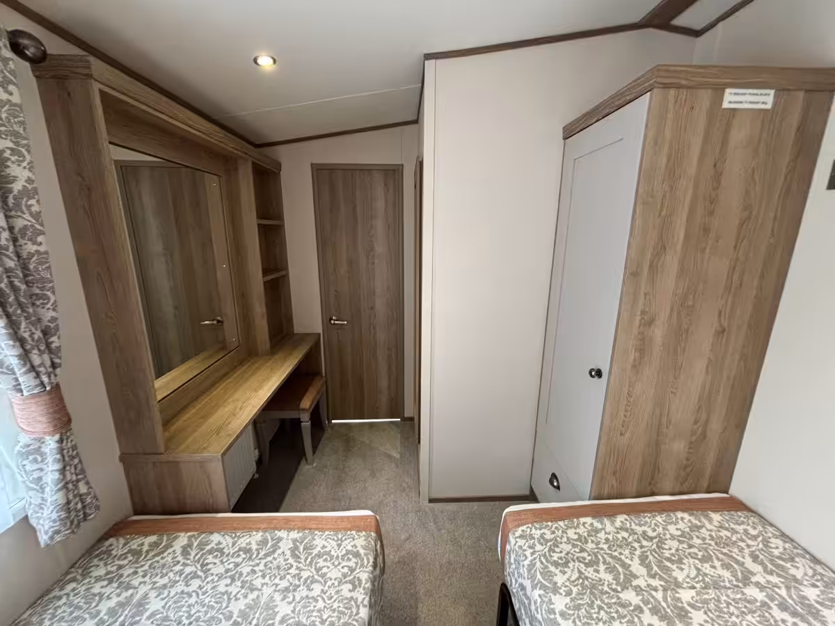 Twin bedroom storage and vanity area in the 2021 ABI Adderstone Elite for sale at Elm Bank Coastal Park in Berwick, Northumberland.