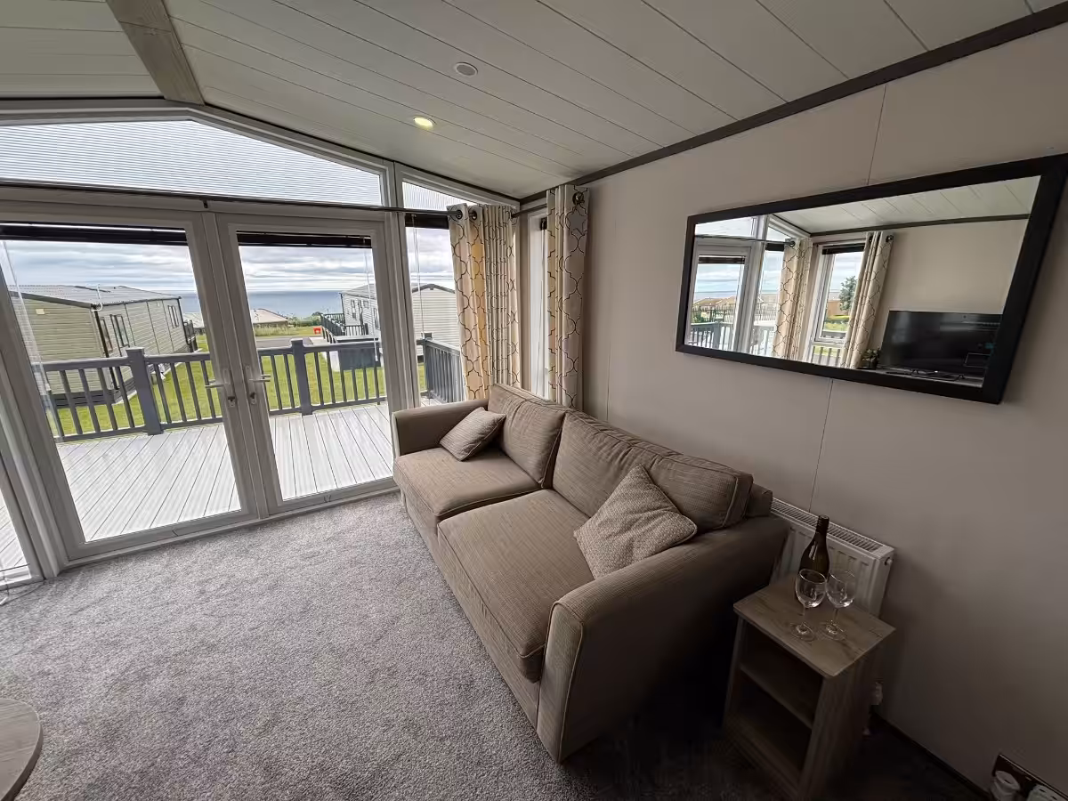 Living room and patio doors in the 2021 Victory Lakewood Lodge for sale at Elm Bank Coastal Park in Spittal, Berwick-upon-Tweed, Northumberland.