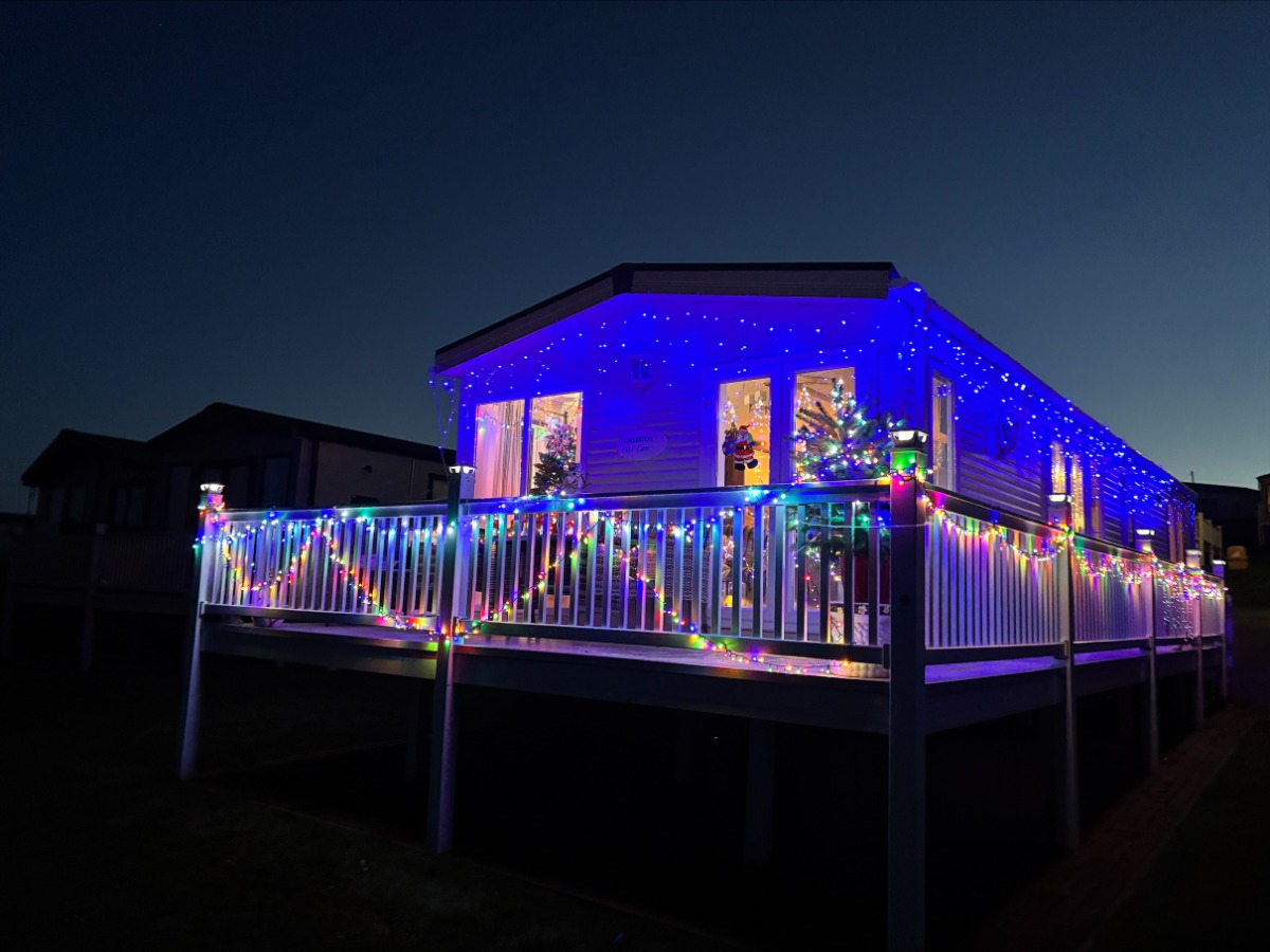An owners caravan at Elm Bank Coastal Park in Berwick, Northumberland, decorated with bright colorful Christmas lights and decorations