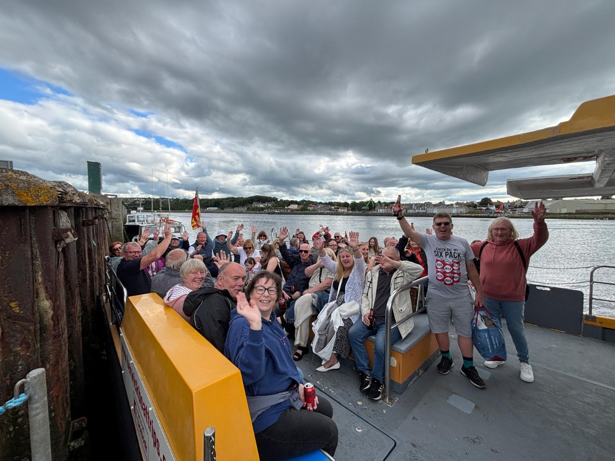 Owners from Elm Bank Coastal Park in Berwick, Northumberland sitting on a boat waving at the start of the hugely popular annual summer evening boat trip.